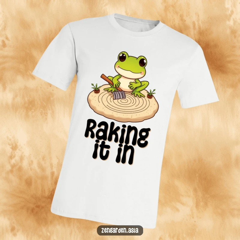 Funny Frog Zen Master T-Shirt depicting a frog carefully raking intricate patterns in a miniature sand garden, promoting calm.